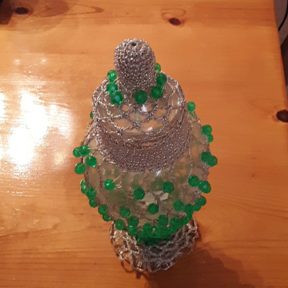 Glass beaded bottle with lid.